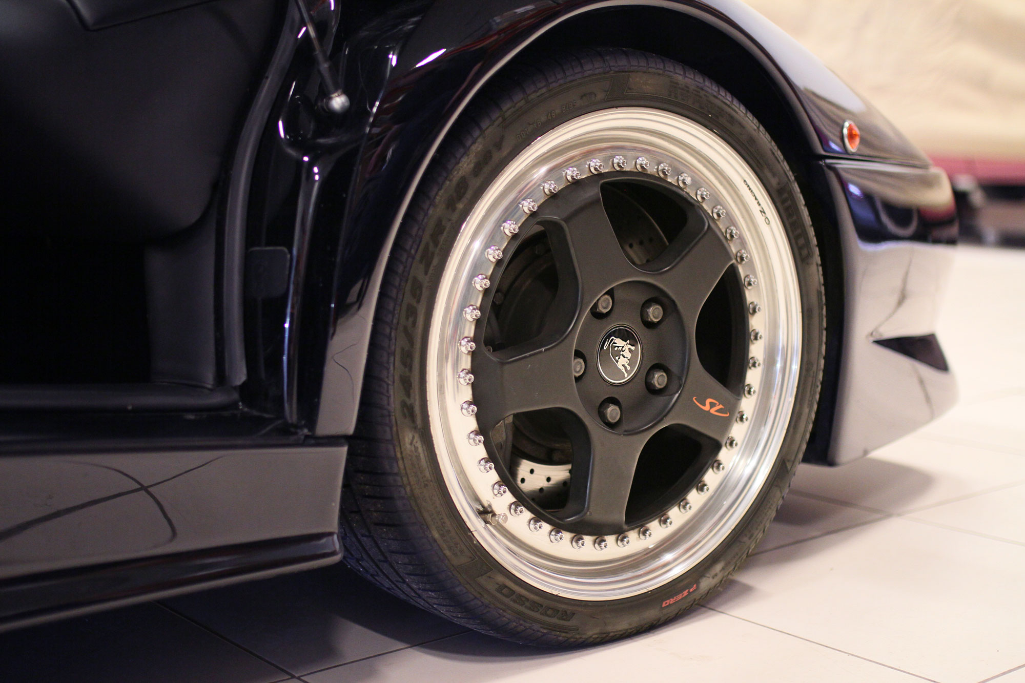 Devils Black Lamborghini Diabo SV standing on the garage floor with amazing black and silver rims