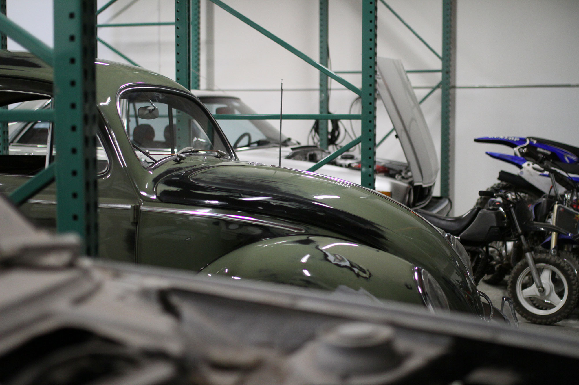 Green VW Beetle with patina paint, SEMA show car with Honda Accord in the background