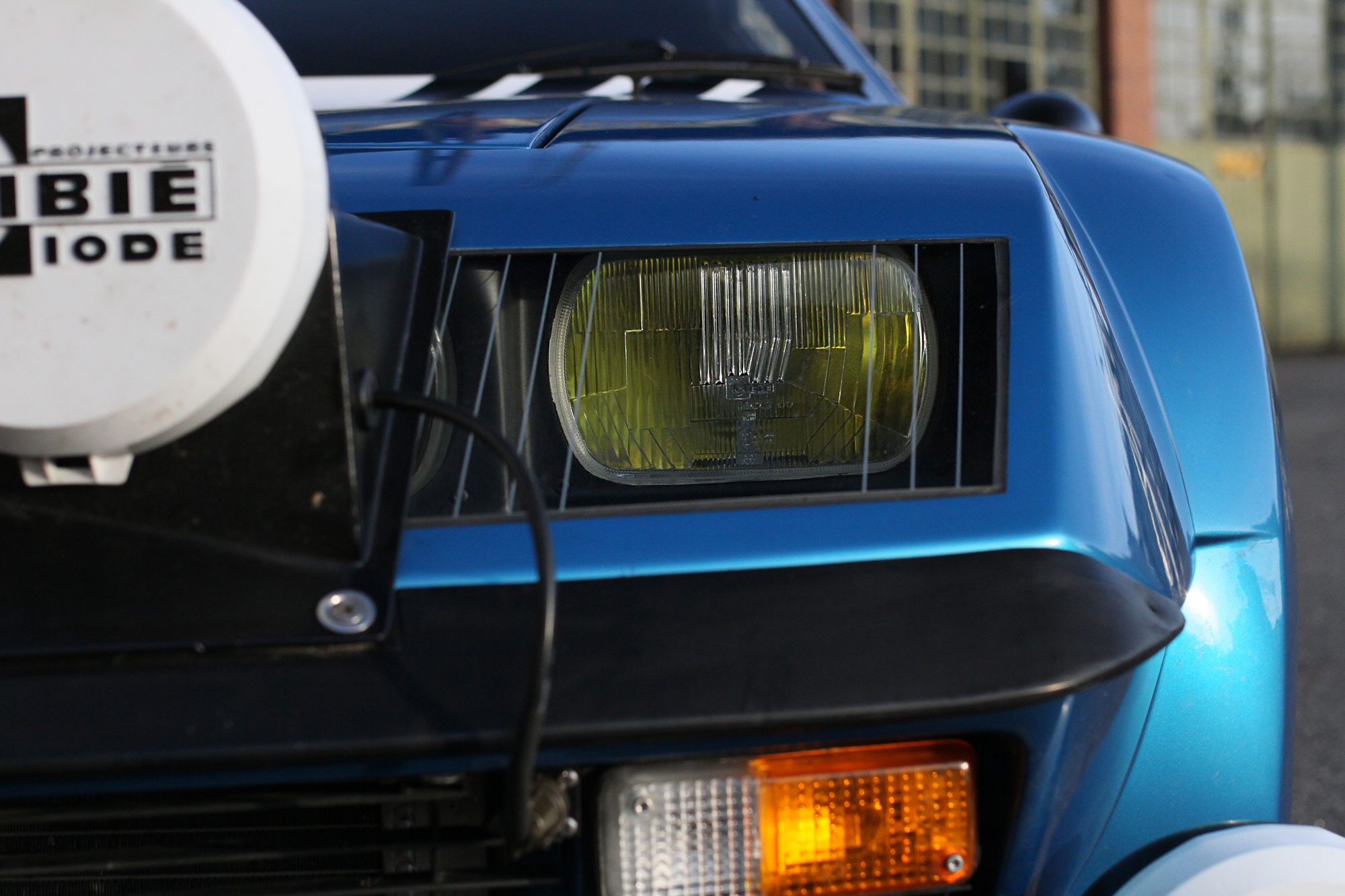 The front of the Renault Alpine A310 with yellow headlights and extra lights. 