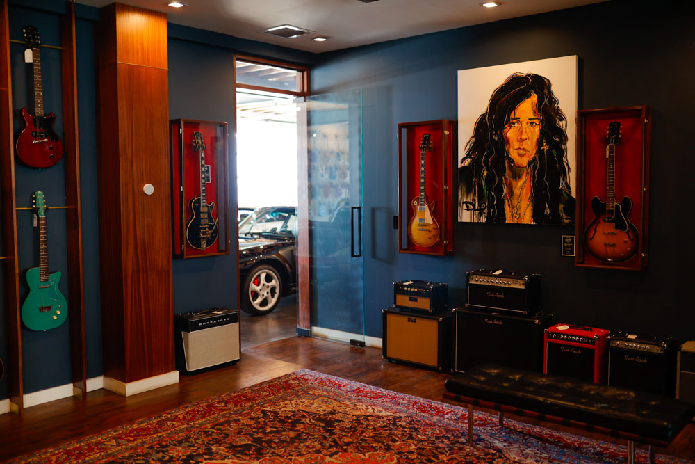 Yngwe-malmsteen-on-the-wall-in-a-guitar-room-with-a-porshce-outside